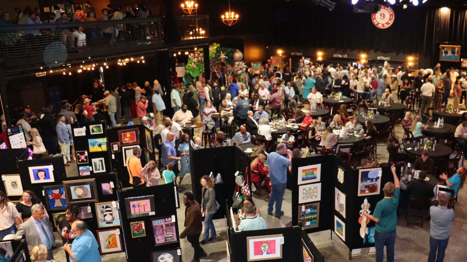 people viewing art at Birch Tree's 2025 Art Show
